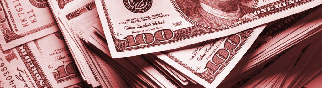 Stacks of hundred-dollar bills in red tint.