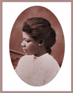 Vintage sepia portrait of a woman with elegant hairstyle in profile.