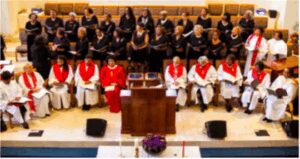 A church choir and clergy seated during a service.