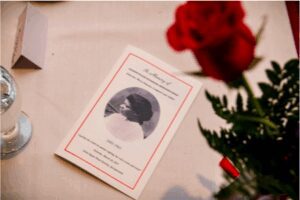 Elegant wedding invitation card with a photo and red rose.