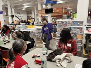 Volunteers sorting donated clothes in a busy community center.