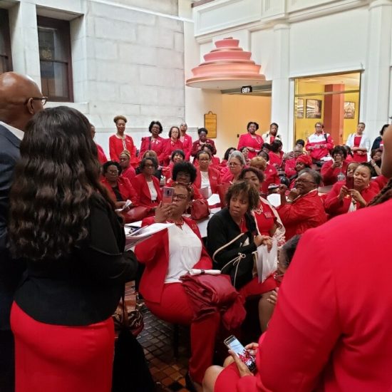 A group of students in red uniforms gathered indoors for an event.