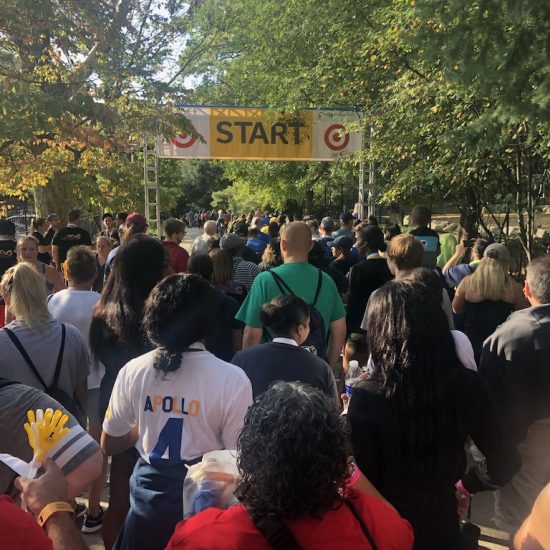 Crowd gathered at the starting line of an outdoor race event.