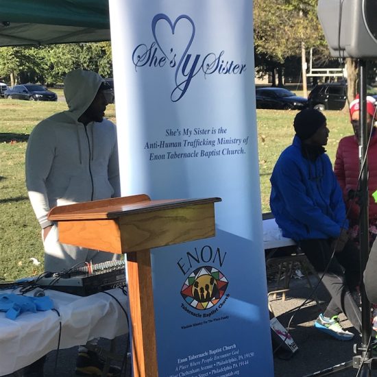 A banner promotes a support organization at an outdoor event.
