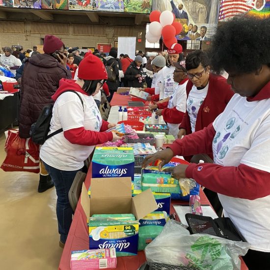 Volunteers packing school supplies at a community event.